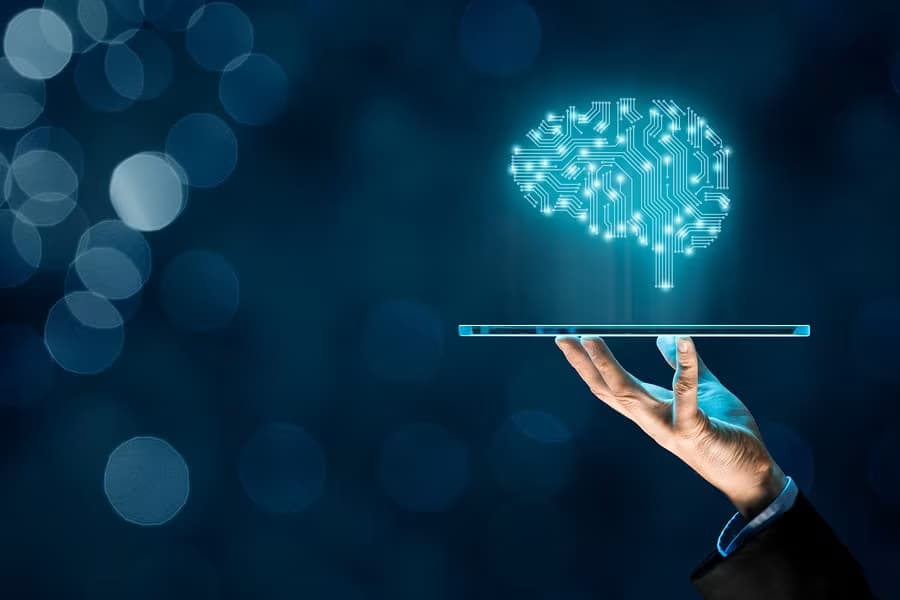 Ilustração de um profissional segurando um tablet que projeta um cérebro de inteligência artificial, representando a profissão de Engenheiro de IA, destaque no LinkedIn em 2026